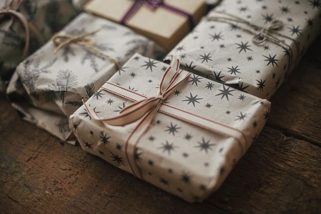Stylish rustic christmas gifts with ribbons close up Eco friendly packaging Merry Christmas