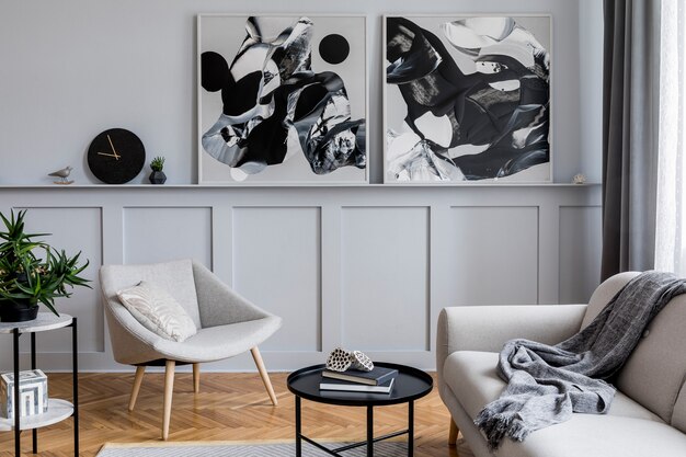 Stylish scandinavian home interior of living room with design gray sofa, armchair, marble stool, black coffee table, modern paintings, decoration, plant and elegant personal accessories in home decor.