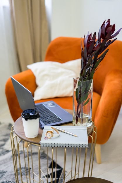 Stylish scandinavian interior of living room with design green\
velvet sofa, gold pouf, wooden furniture, cacti, carpet, cube, copy\
space and mock up poster frames. template. . high quality\
photo