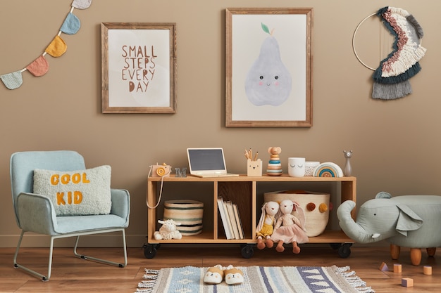 Stylish scandinavian kid room interior with toys, teddy bear, plush animal toys, mint armchair, furniture, decoration and child accessories. Brown wooden  poster frames on the wall. 