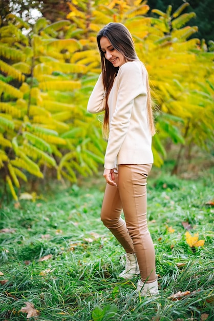 Stylish seasonal young person outdoor Pretty lifestyle woman walking outdoor in the park