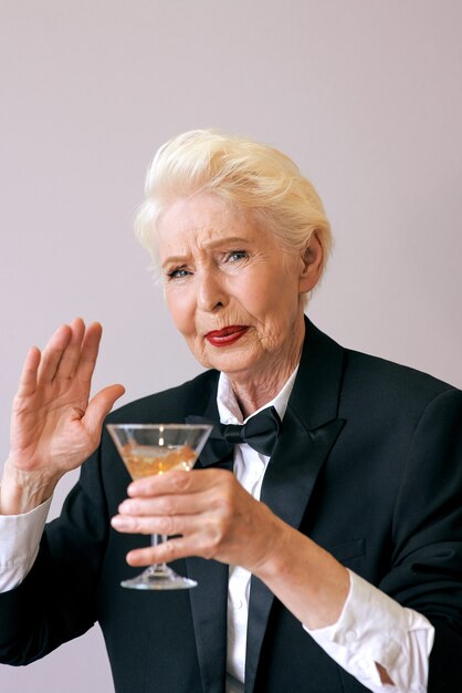 stylish senior woman refusing from alcohol at the party