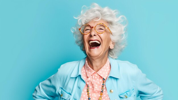 Photo stylish senior woman showing devil horns gesture on pink background