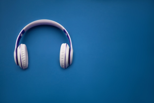 Stylish Silver Dj Headphones. Minimal concept. Creative flat lay photo with earphones.