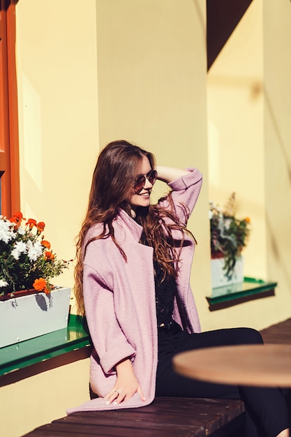 Stylish smiling woman in sunglasses