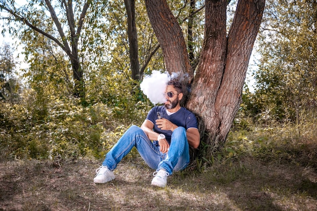 Stylish smoker with electronic smoke device in the fresh air