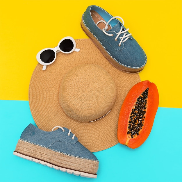 Stylish summer look. straw hat and denim shoes. flat lay. beach lover concept