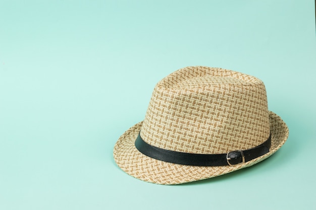 Stylish summer men's hat with a strap on a blue background. Classic men's headdress.