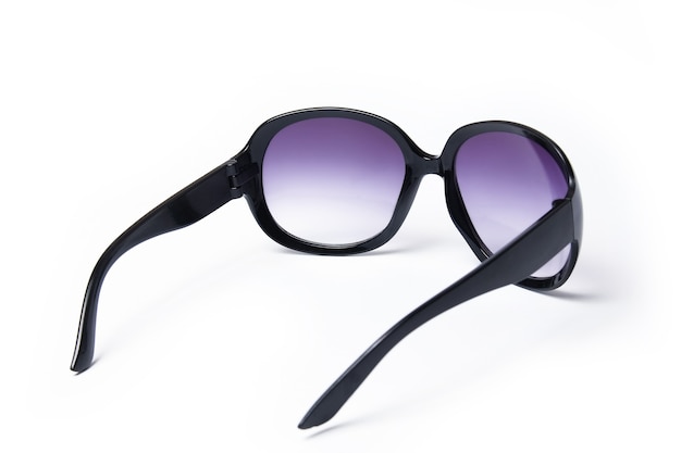 Stylish sunglasses on a white surface