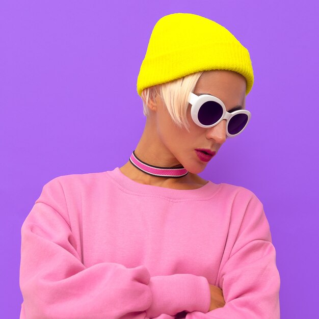 Stylish swag girl in fashion accessories. Beanie Cap, Sunglasses and choker. Candy colours  vibes