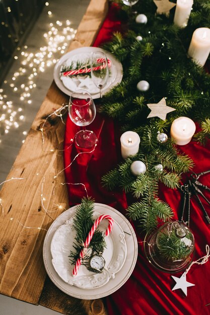 Stylish table setting with burning candles and Christmas decorations