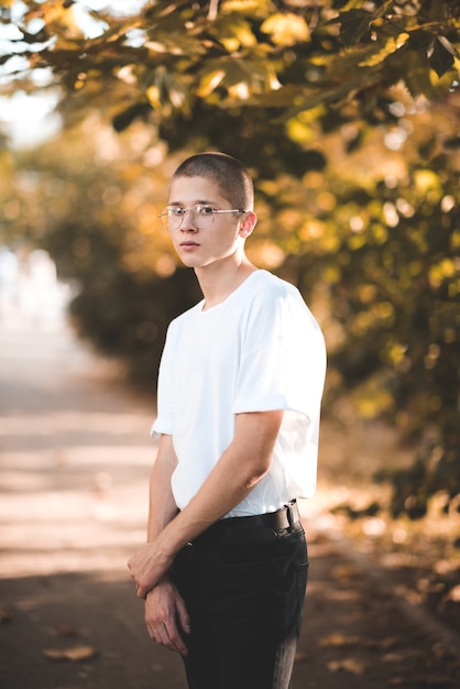 Stylish teen boy wearing trendy clothes and glasses