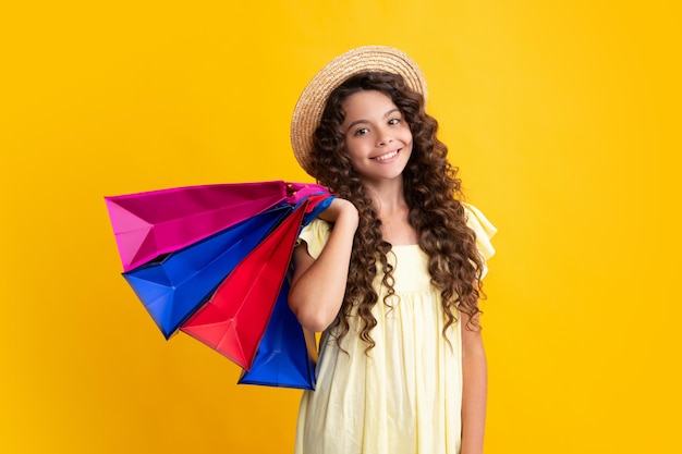 Stylish teen girl with shopping sale bags Kid holding purchases Happy teenager positive and smiling emotions of teen girl