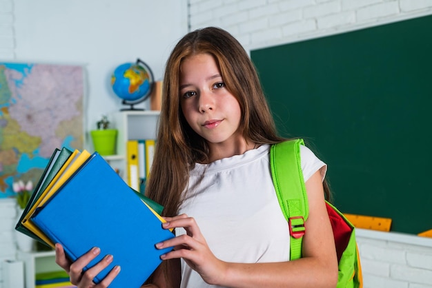 Stylish teen schoolgirl studying homework during lesson education concept literature