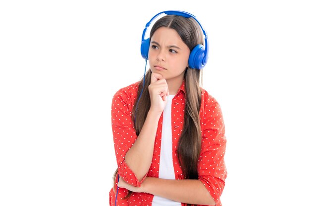 Stylish teenage girl listening to music with headphones Kids lifestyle concept Wireless earphones Serious teenager girl