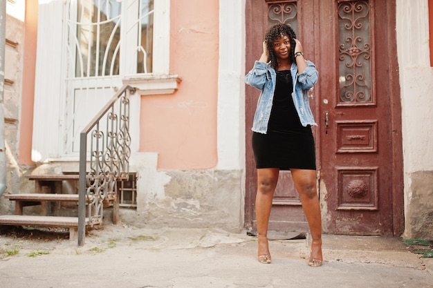 Stylish trendy afro france curly woman posed at autumn day in jeans jacket Black african female model