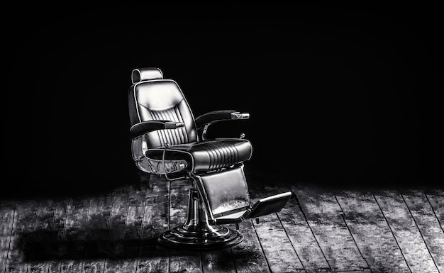 Photo stylish vintage barber chair. professional hairstylist in barbershop interior. copy space. black and white.