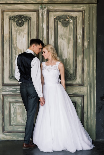 Stylish wedding couple in elegant outfits