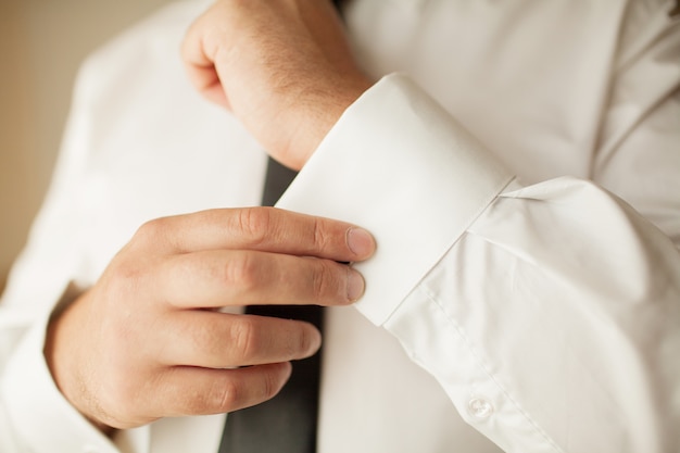 Stylish wedding morning cooking groom in a suit