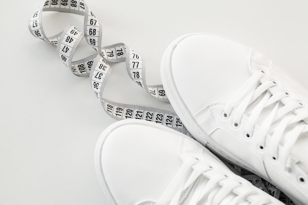 Stylish white fashion sneakers on white .