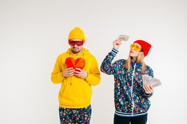 Stylish woman chosing money instead man's heart over white background