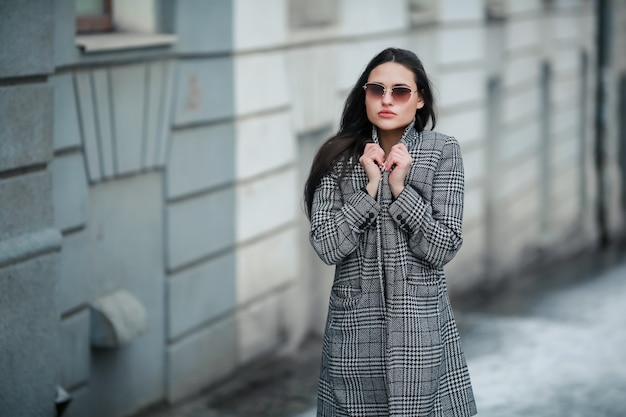 Stylish woman dressed in casual style in winter on the street