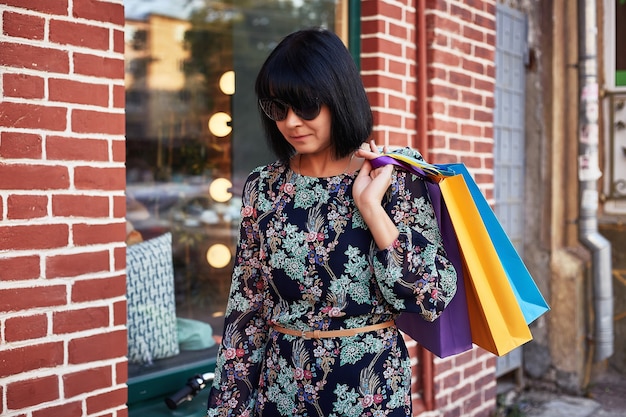 Stylish woman holding shopping bags