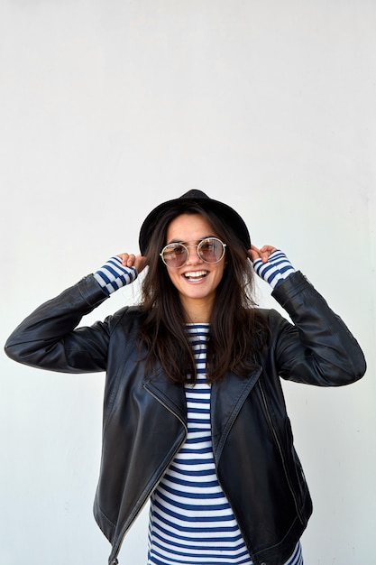 Stylish woman in leather jacket and hat