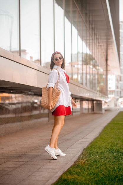 A stylish woman in a red dress in the street