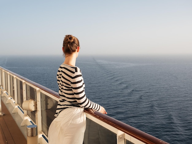 Stylish woman standing on the empty deck