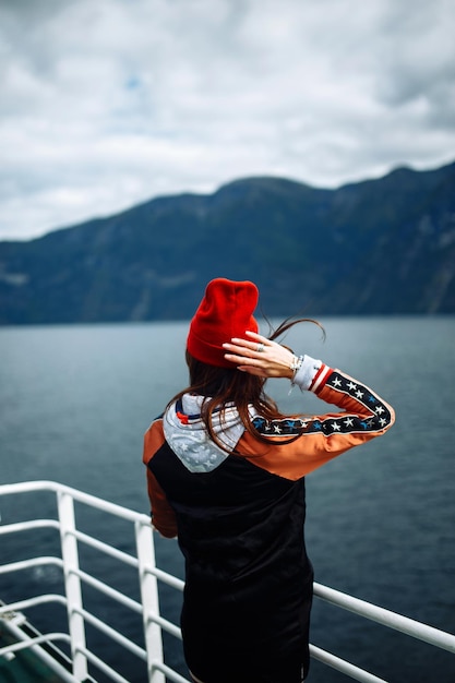 Stylish woman takes a photo on the phone in the travelling The girl tourist photographs