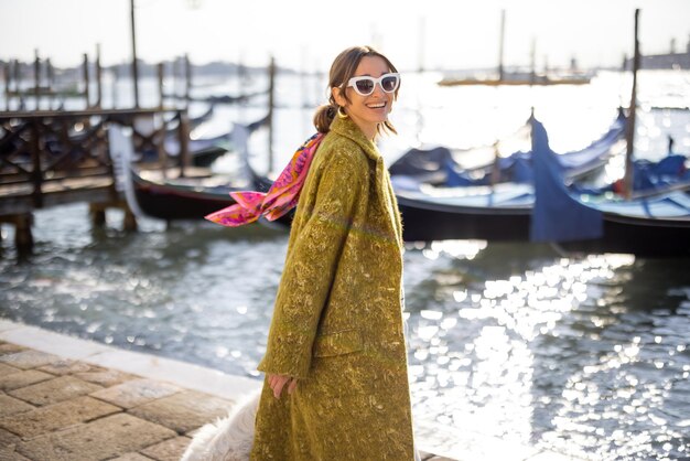 Stylish woman walking in Venice Italy