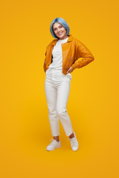 Stylish woman with blue hair in studio