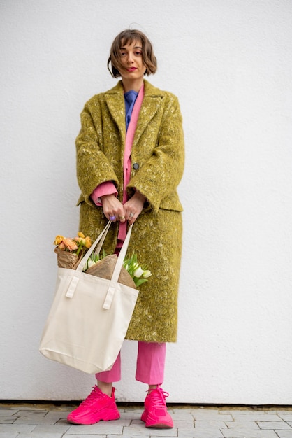 Stylish woman with tote bag on background