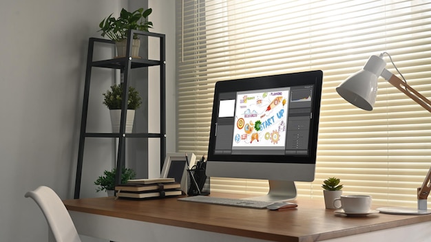 Stylish workplace Cozy home office interior with computer monitor stationery books and lamp