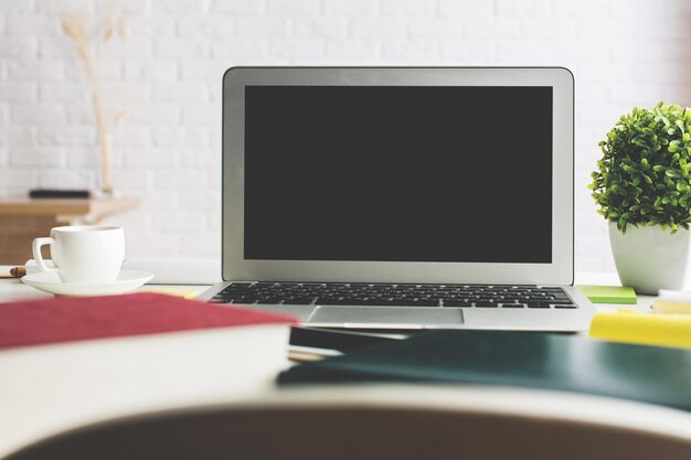 Stylish workplace with empty laptop screen