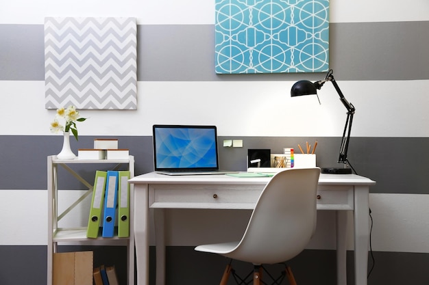 Stylish workplace with laptop at home
