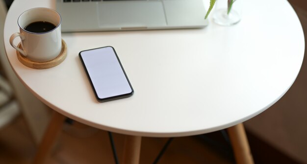 Photo stylish workspace with blank screen smartphone