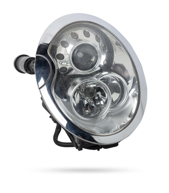 Stylish xenon headlight of a German car optical equipment with a lamp inside on a white isolated background Spare part for auto repair in a car workshop