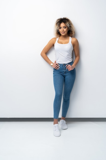 Stylish young black woman standing isolated