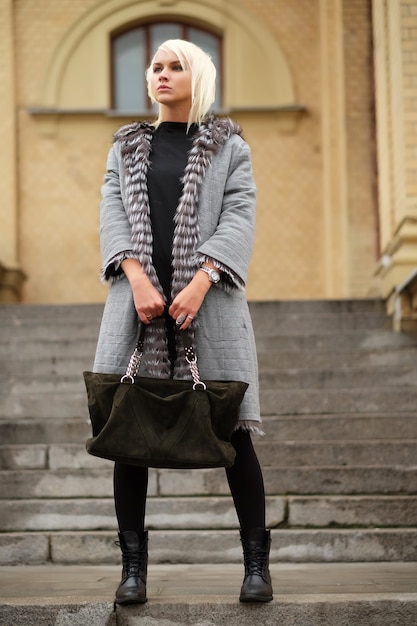 Stylish young blond woman wearing a winter look