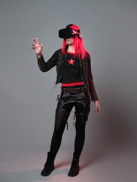 Photo stylish young gamer in a virtual reality helmet playing in simulations