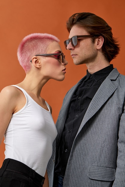 Stylish young hipster couple in sunglasses, posing next each other