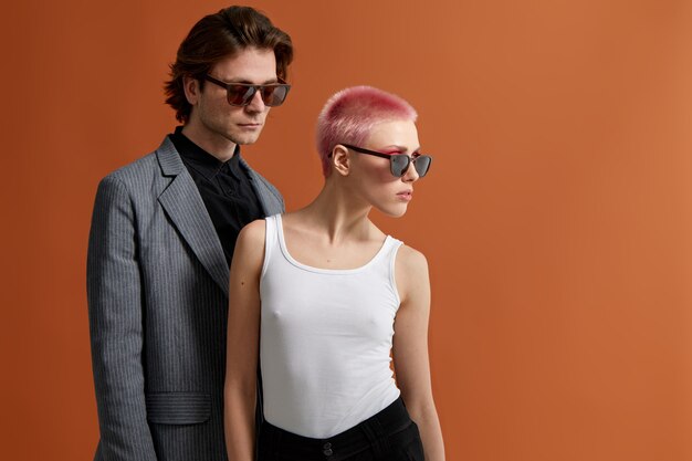 Stylish young hipster couple in sunglasses, posing together