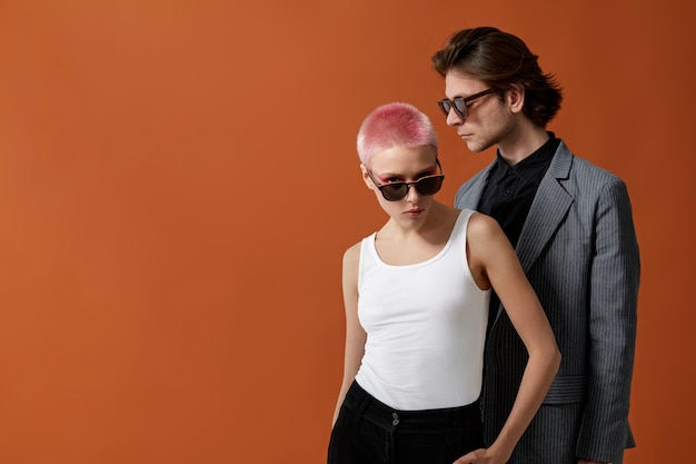 Stylish young hipsters woman and man in sunglasses, posing together