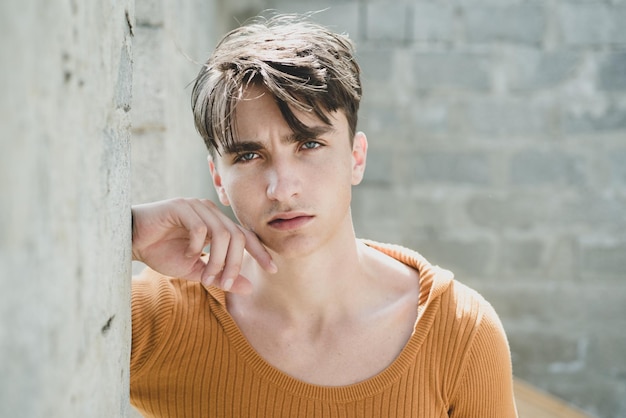 Stylish young man against a grey wall.