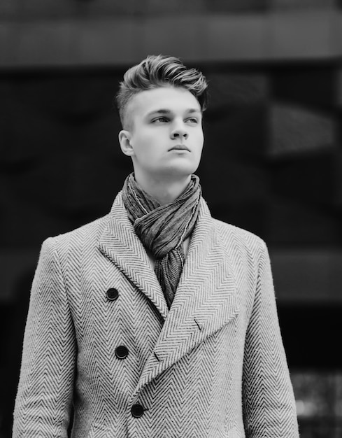 Stylish young man in a coat. monochrome shot