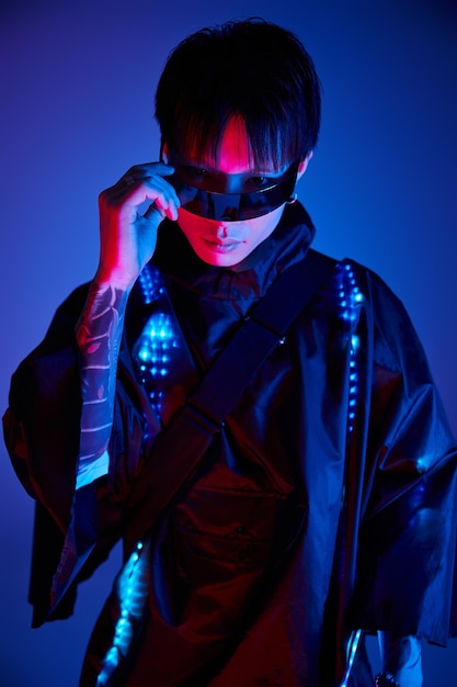 stylish young man in neon lights showcasing modern fashion and confidence at an urban setting