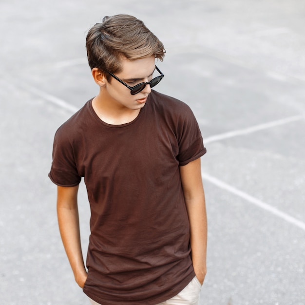 Stylish young man in sunglasses and t-shirt on a summer day.