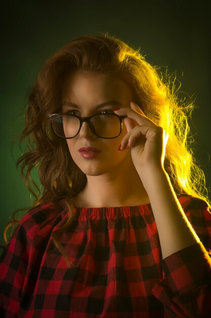 Stylish young model wearing glasses. Closeup portrait